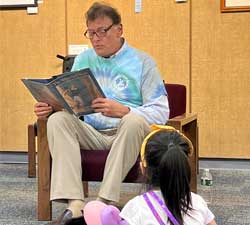 Supervisor Crummey reads to a group of children at the Library’s Kick Off to Summer Reading – All Together Now